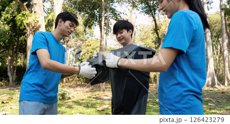 Youth volunteers collecting waste and working together for environmental conservation. Youth volunteers collecting waste and working together for environmental conservation. 126423279