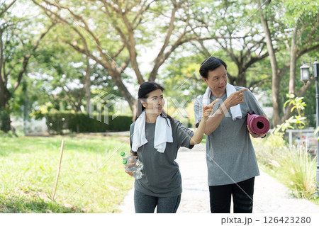 Wellness walking routine for seniors: couple enjoying walk in the park Wellness walking routine for seniors: couple enjoying walk in the park 126423280