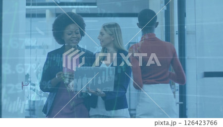 Image of financial data processing over diverse female colleagues using laptop in office 126423766