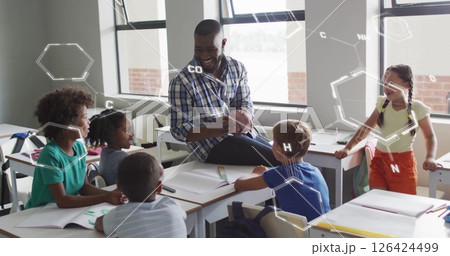Image of chemical formula over diverse schoolchildren learning with male teacher in classroom Image of chemical formula over diverse schoolchildren learning with male teacher in classroom 126424499
