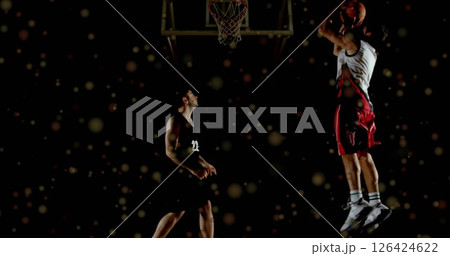 Image of moving spots over diverse male basketball players playing basketball 126424622
