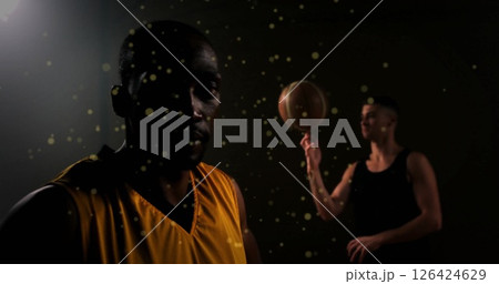 Image of moving spots over diverse male basketball players playing with basketball 126424629