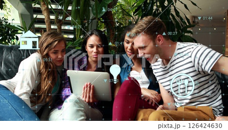 Image of financial data processing with icons over diverse colleagues using tablet in office 126424630