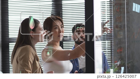Image of ecology icons over diverse colleagues talking in office Image of ecology icons over diverse colleagues talking in office 126425007