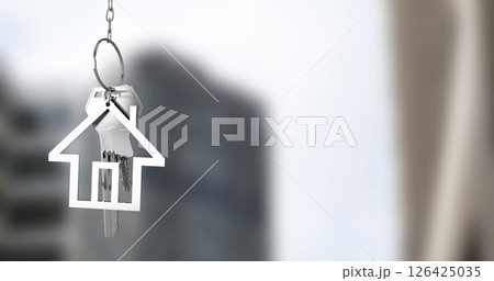 House-shaped keychain image over blurred urban background 126425035