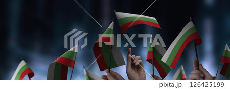 Bulgaria flags in their hands on a blurred urban background 126425199