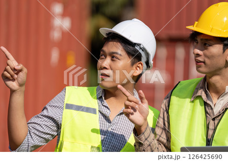 Strategic Discussion. Young engineers planning logistics and strategies outdoors. Strategic Discussion. Young engineers planning logistics and strategies outdoors. 126425690