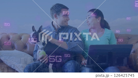 Image of 5g text repeated over happy caucasian couple with dog using laptop at home Image of 5g text repeated over happy caucasian couple with dog using laptop at home 126425745