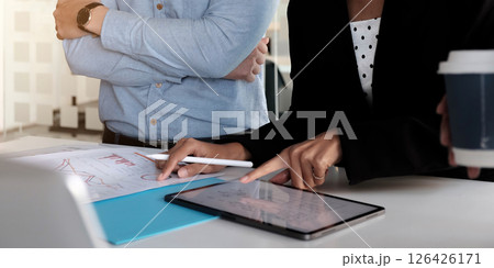 Asian business adviser meeting to analyze and discuss the situation on the financial report in the meeting room.Investment Consultant,Financial advisor and accounting concept 126426171