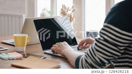 Close-up image of young professional male manager using laptop at he office, businessman working from home via portable computer Close-up image of young professional male manager using laptop at he office, businessman working from home via portable computer 126426218