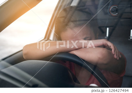 Sleepy woman While she was driving on the road. Concept of health and driving safety 126427494