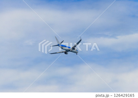 Passenger airplane flying in the blue sky 126429165