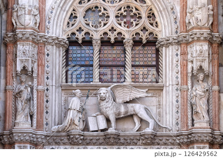Detail of the Porta della Carta entrance to the Doge's Palace in Venice, Italy, depicting Doge Francesco Foscari kneeling before the Lion of St. Mark 126429562
