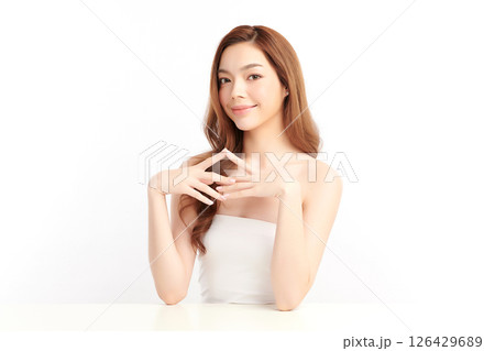A beautiful young Asian woman with clean, fresh skin against a white background. Skincare, facial treatment, cosmetology, beauty, and spa. An elegant portrait of an Asian woman. A beautiful young Asian woman with clean, fresh skin against a white background. Skincare, facial treatment, cosmetology, beauty, and spa. An elegant portrait of an Asian woman. 126429689