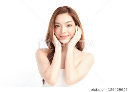 A beautiful young Asian woman with clean, fresh skin against a white background. Skincare, facial treatment, cosmetology, beauty, and spa. An elegant portrait of an Asian woman. 126429693