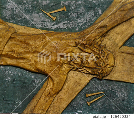 11th Station of the Cross - Crucifixion: Jesus is nailed to the cross 126430324