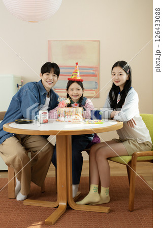 A family enjoying their daughter's birthday party at home A family enjoying their daughter's birthday party at home 126433088