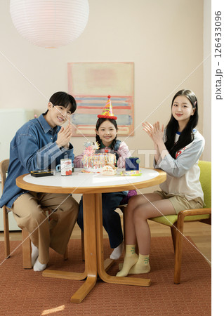 A family enjoying their daughter's birthday party at home 126433096