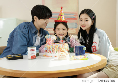 A family enjoying their daughter's birthday party at home A family enjoying their daughter's birthday party at home 126433100