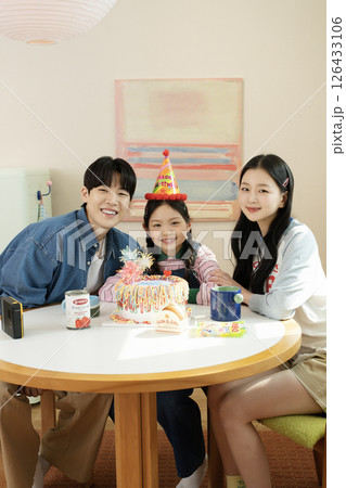 A family enjoying their daughter's birthday party at home A family enjoying their daughter's birthday party at home 126433106