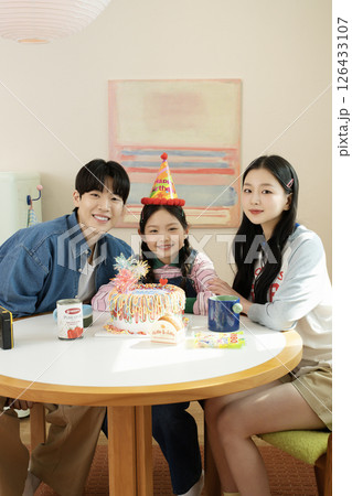 A family enjoying their daughter's birthday party at home A family enjoying their daughter's birthday party at home 126433107