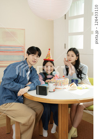 A family enjoying their daughter's birthday party at home 126433110