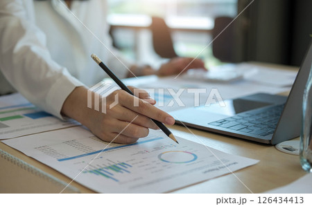 Close up Businessman using calculator and laptop for calaulating finance, tax, accounting, statistics and analytic research concept 126434413