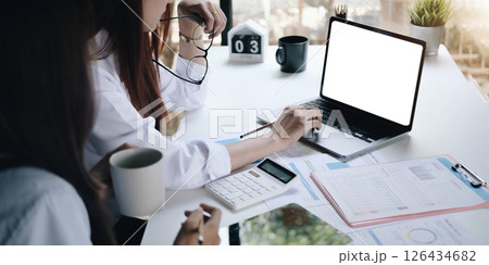 Businessman working on analysis charts and graphs showing results.Her hand holds the pen and points to the graph.Business analysis and strategy. Businessman working on analysis charts and graphs showing results.Her hand holds the pen and points to the graph.Business analysis and strategy. 126434682