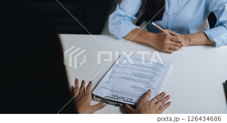 Application for jobs and interviews concept, female is hoping for a resume and recruiter considering application, hr manager making hiring decision. Application for jobs and interviews concept, female is hoping for a resume and recruiter considering application, hr manager making hiring decision. 126434686
