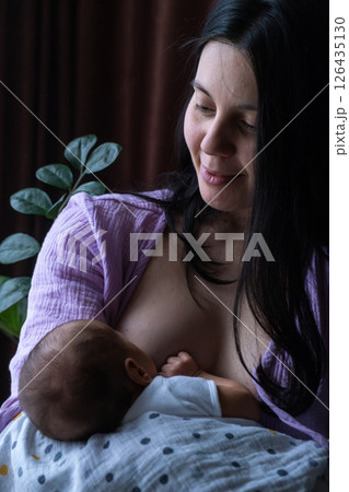 Mother Breastfeeding Baby by Window Mother Breastfeeding Baby by Window 126435130
