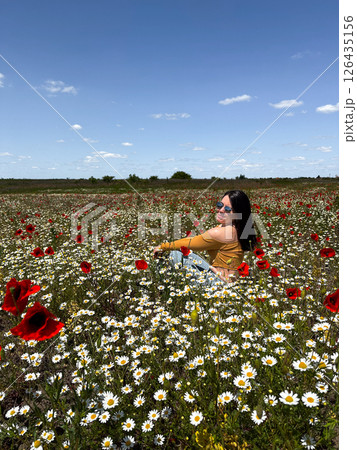 Woman Relaxing in a Field of Wildflowers Woman Relaxing in a Field of Wildflowers 126435156