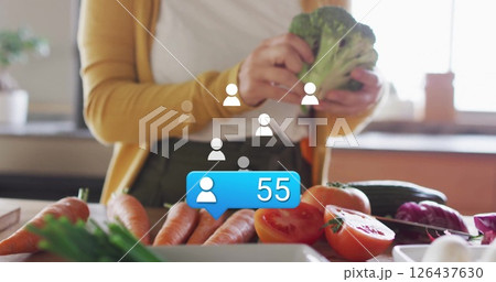 Preparing vegetables, social media follower count image over kitchen scene 126437630