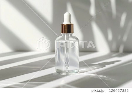 Natural oil cosmetics. Dropper glass Bottle Mock-Up. Oily cosmetic pipette. Face and body treatment. Spa concept. Mineral organic liquid. Front view. Beauty products. Blank packaging gel, white table 126437823