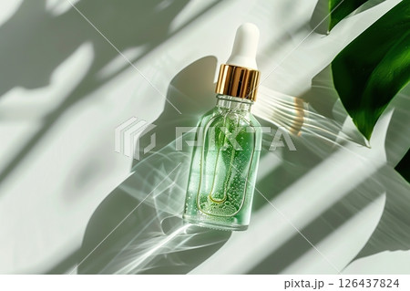 Natural oil cosmetics. Dropper glass Bottle Mock-Up. Oily cosmetic pipette. Face and body treatment. Spa concept. Mineral organic liquid. Top view. Beauty products. Blank packaging gel, white table 126437824