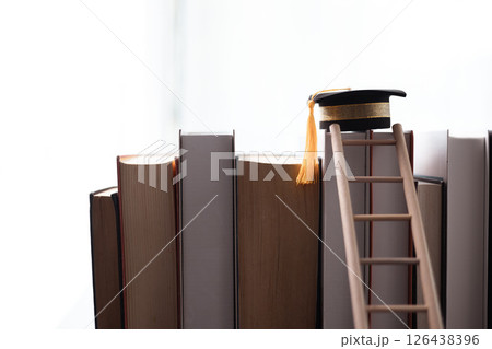 Graduate, diploma in global business, reflected on academic journey, which began as student studying diligently at college, ready to make an impact on earth. degree, graduation, abroad, book, hat. 126438396
