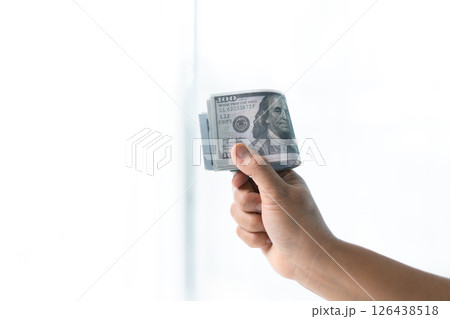 Woman carefully counted the dollar bills in her hand, managing her finances and saving money for future expenses. dollar, hand, money, cash, woman, finance, currency, bill, banknote, saving, business. 126438518