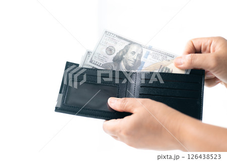 She carefully counted the dollar bills in her hand, managing her business finances and prioritizing saving for future investments. dollar, finance, money, cash, currency, bill, banknote, business. 126438523