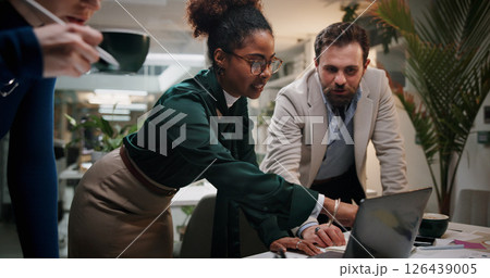 Speaking, project or business people on laptop for teamwork, collaboration or investment at night. Manager, finance or financial advisor in office for late meeting, account budget or risk management 126439005