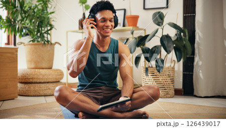 Home, man and tablet with headphones for exercise, fitness podcast and application for audio track. House, male person and break with technology for social media, workout playlist or music with smile 126439017