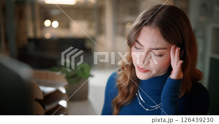 Headache, stress and businesswoman in office at night with fatigue, exhaustion and burnout for deadline. Mistake, overworked and female creative editor with migraine for publishing at magazine agency 126439230