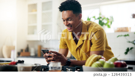 Cellphone, kitchen and hands of man with recipe online for cooking healthy, wellness or diet dinner. Phone, research and person on mobile app for supper preparation tutorial or instructions in home. Cellphone, kitchen and hands of man with recipe online for cooking healthy, wellness or diet dinner. Phone, research and person on mobile app for supper preparation tutorial or instructions in home. 126439313