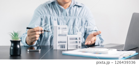 Real estate agent helped the client secure a mortgage loan for their property investment, ensuring the contract was properly handled by the broker. investment, property, estate, loan, real, mortgage. 126439336