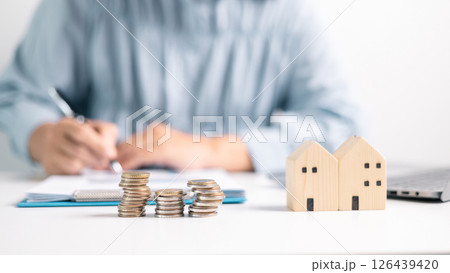 Investment in a home often involves securing a mortgage loan, with a finance agent helping to manage business and property aspects of the house to ensure best use of your money. investment, loan. Investment in a home often involves securing a mortgage loan, with a finance agent helping to manage business and property aspects of the house to ensure best use of your money. investment, loan. 126439420
