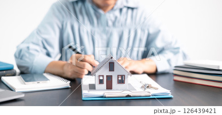 Real estate agent helped the client secure a mortgage loan for their property investment, ensuring the contract was properly handled by the broker. investment, property, estate, loan, real, mortgage. 126439421