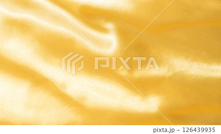 Close-up of gold satin fabric for a background. Close-up of gold satin fabric for a background. 126439935