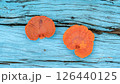 Fan-shaped jelly fungus growing on a blue wooden. 126440125