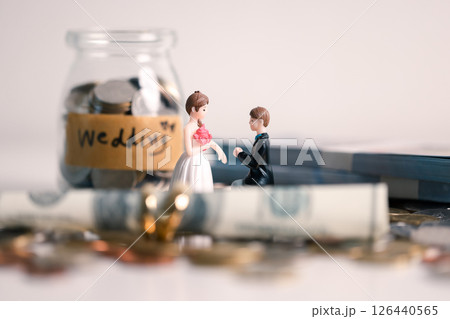 Woman carefully manages her wedding fund, making payments from her bank account and using credit wisely, with the background of sound financial plan supporting her marriage and business commitments. Woman carefully manages her wedding fund, making payments from her bank account and using credit wisely, with the background of sound financial plan supporting her marriage and business commitments. 126440565