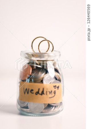 Woman carefully manages her wedding fund, making payments from her bank account and using credit wisely, with the background of sound financial plan supporting her marriage and business commitments. 126440569