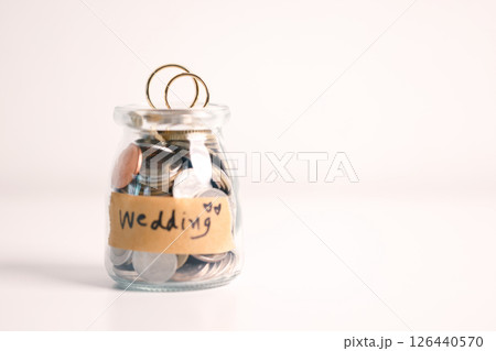 Woman carefully manages her wedding fund, making payments from her bank account and using credit wisely, with the background of sound financial plan supporting her marriage and business commitments. Woman carefully manages her wedding fund, making payments from her bank account and using credit wisely, with the background of sound financial plan supporting her marriage and business commitments. 126440570