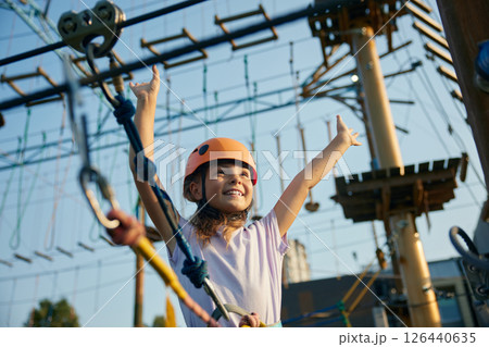 Happy little girl child having fun time at open air rope park Happy little girl child having fun time at open air rope park 126440635